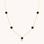Gold necklace with black clover-shaped pendants