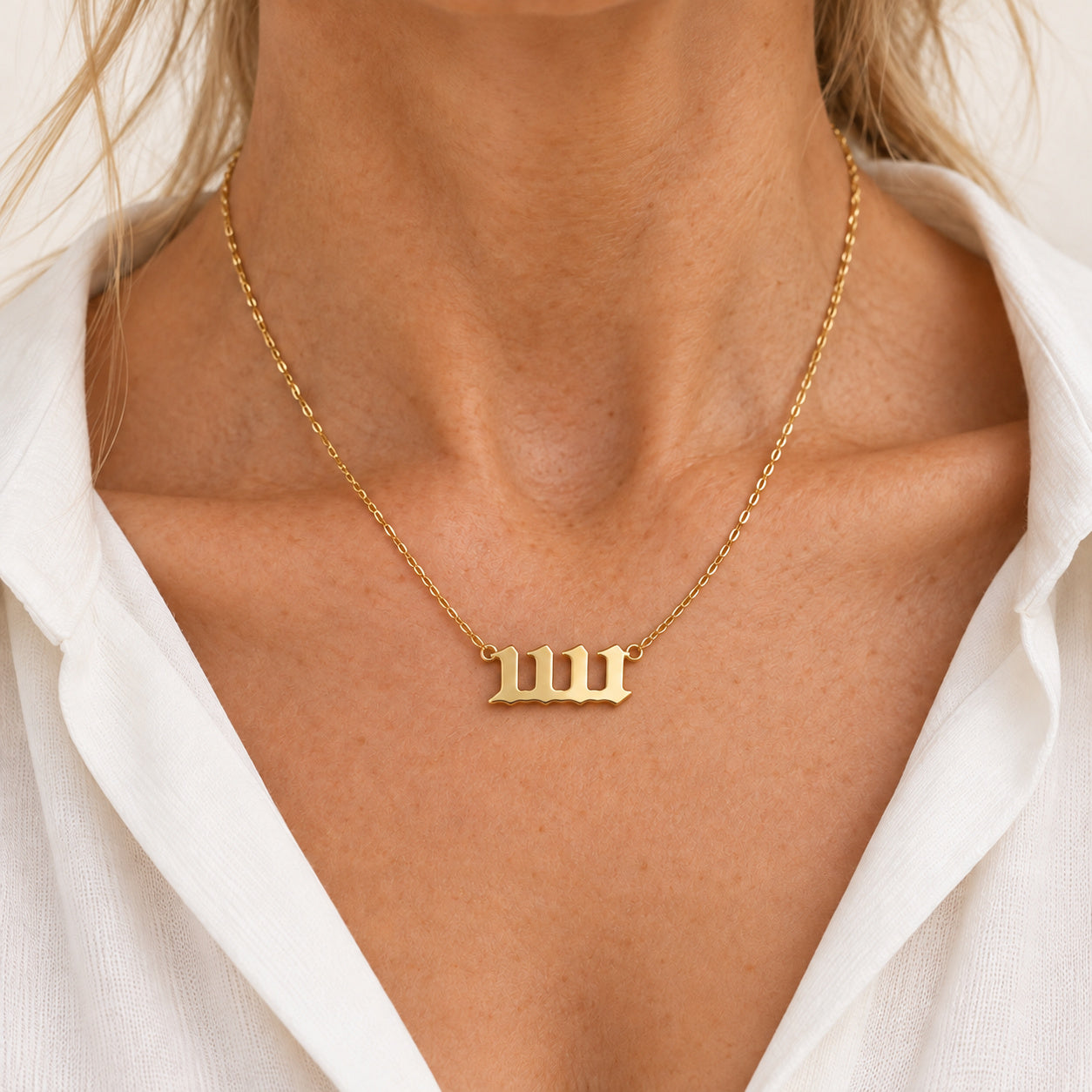 11:11 necklace in gold, worn on a model