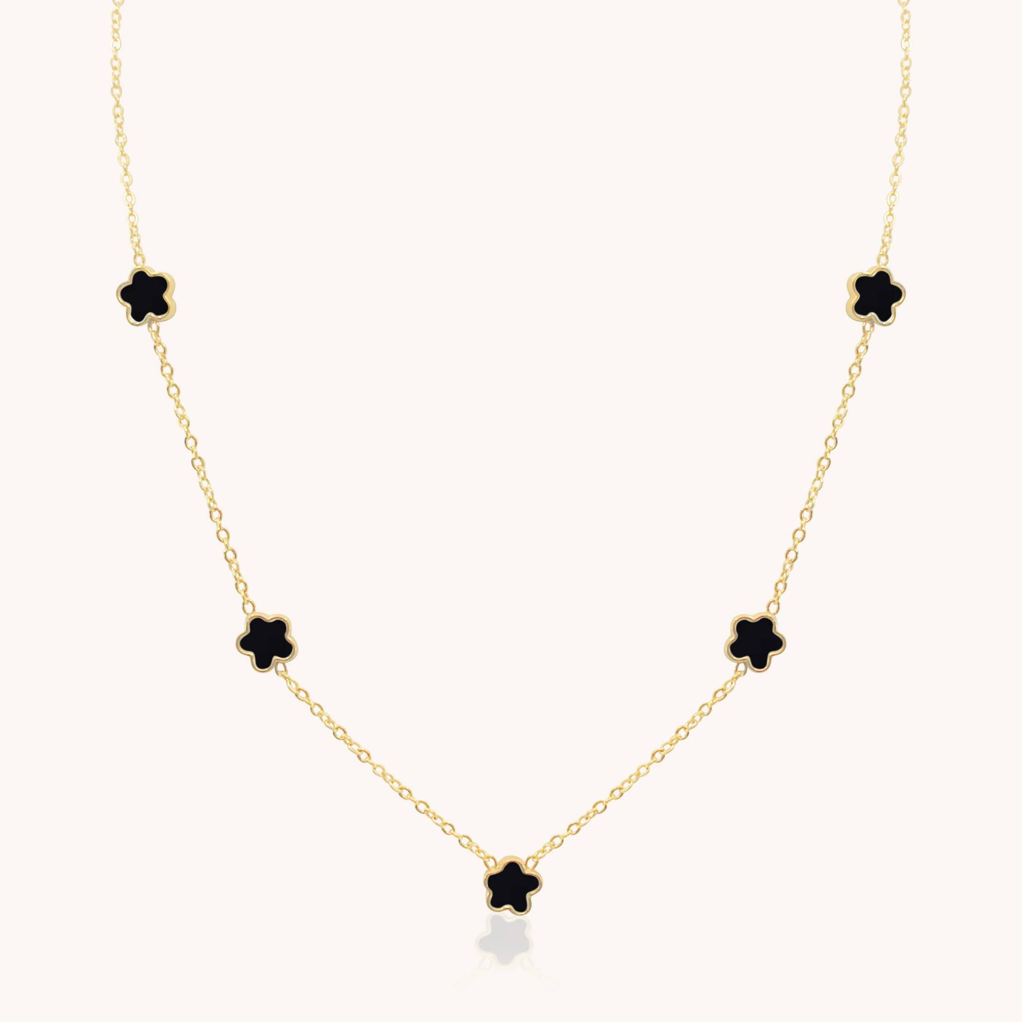 Gold necklace with black clover-shaped pendants